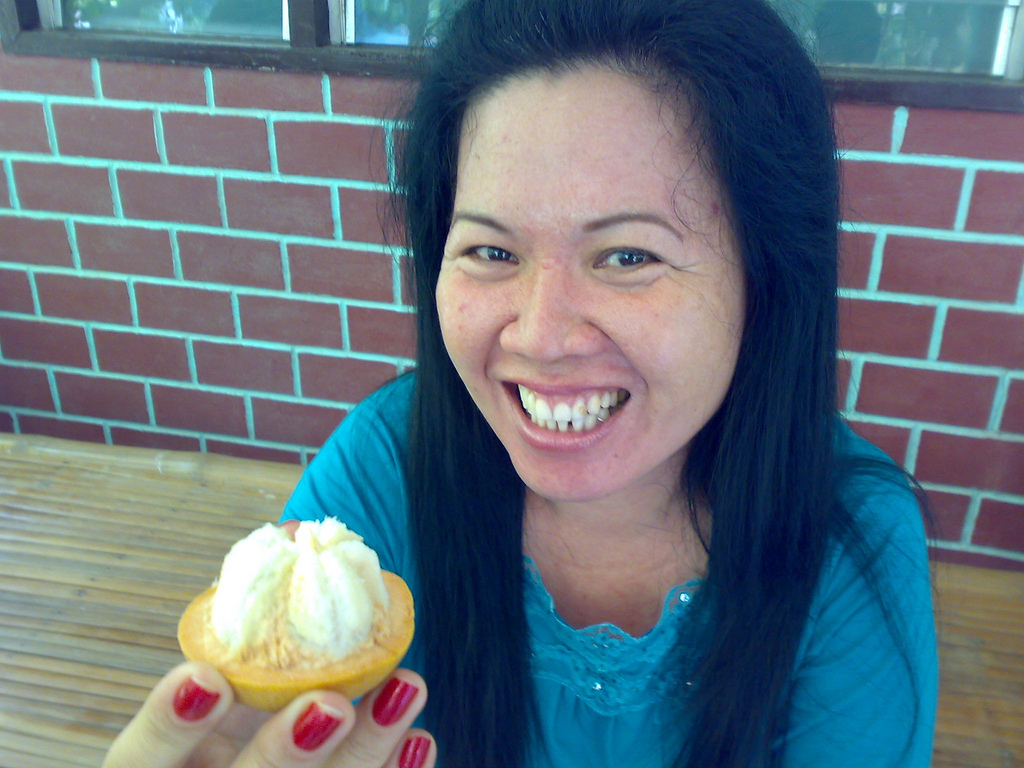 Thai girl eating Santol fruit