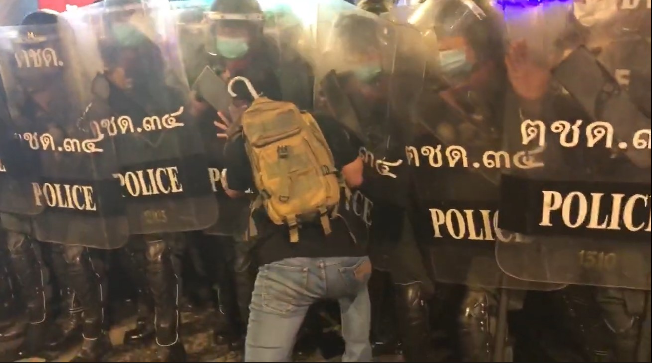Protester pushed by riot police in Bangkok