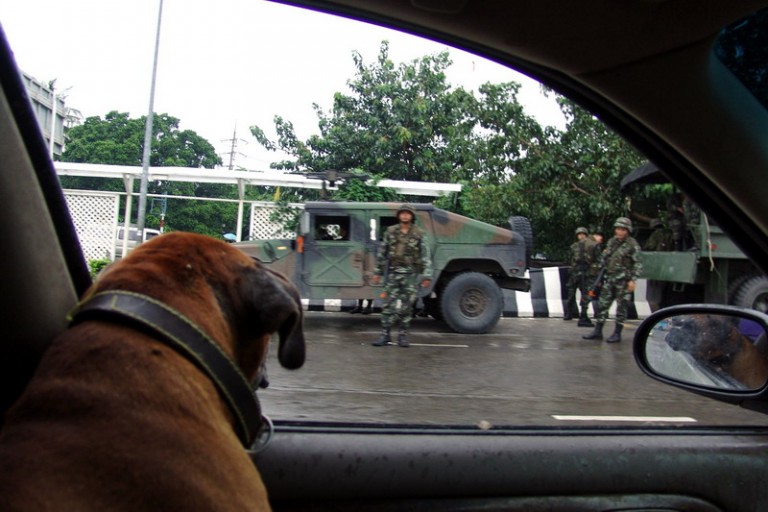 Soldiers of the Royal Thai Army near a Humvee vehicle in the streets of Bangkok after the coup