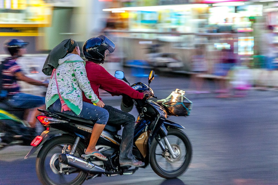 Couple riding a motorcycle in Thailand
