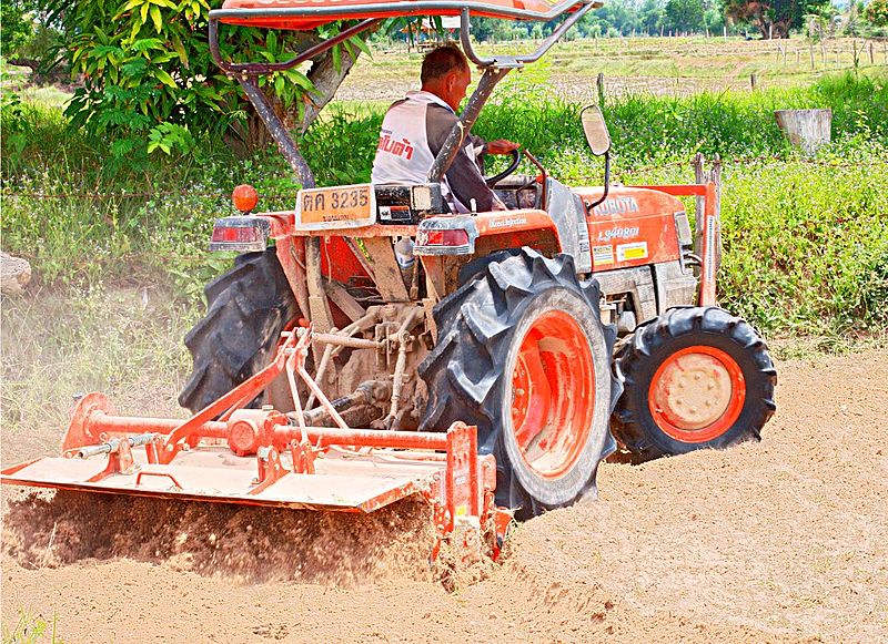 Thai farmer driving a Kubota tractor
