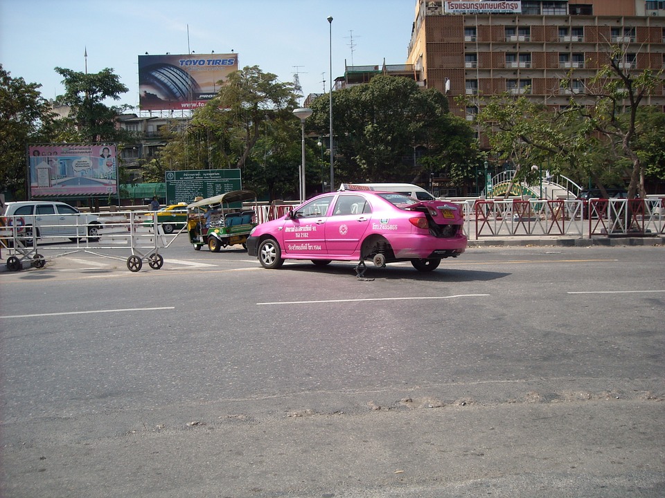 Pink taxi changing tires