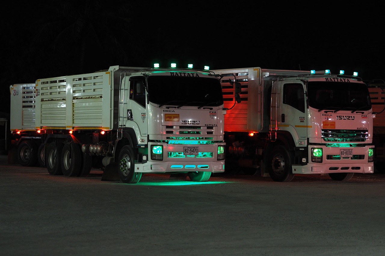 Trucks with greenish colored lights at night in Thailand.