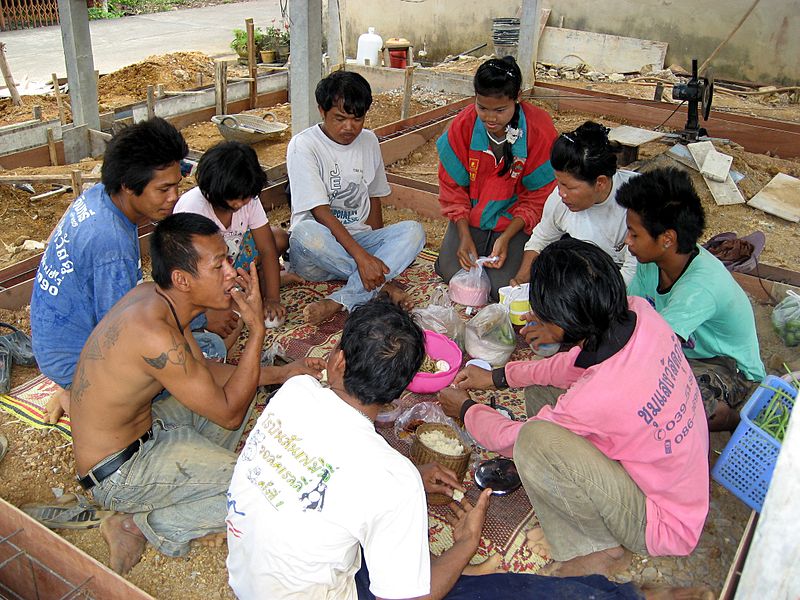 Thai workers having a lunch break on a construction site