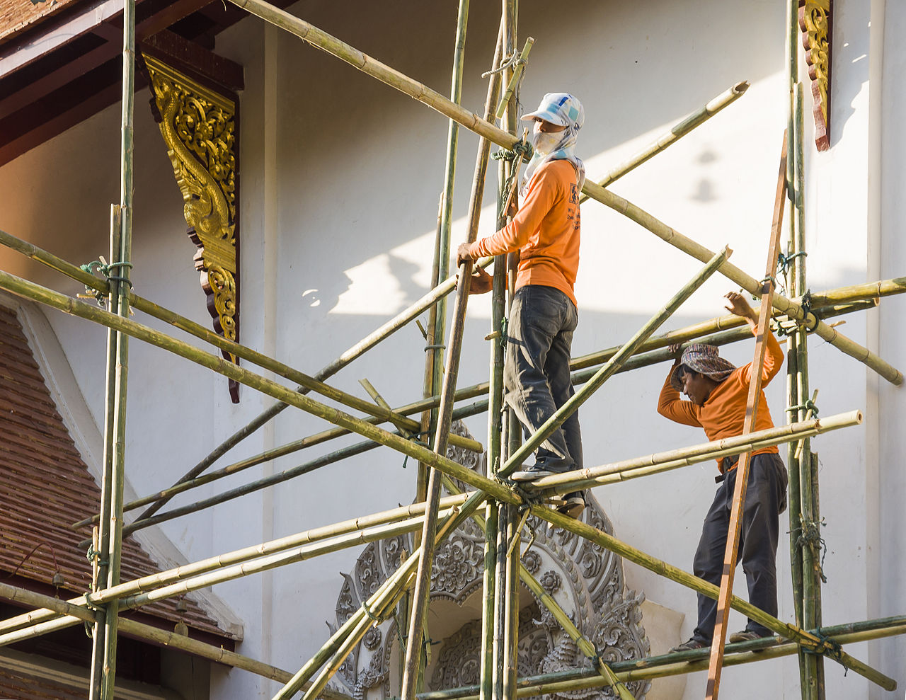 Workers on a bamboo scaffolding during renovation work at Wat Saen Muang Ma Luang in Chiang Ma