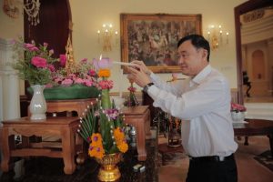 Former Thai PM Thaksin Shinawatra lighting a candle