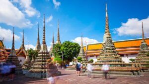 Tourists admire the Buddhist stupas at Wat Pho temple in Bangkok.