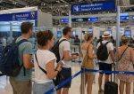 tourists queuing at Suvarnabhumi airport immigration passport control.