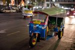 Riding a tuk-tuk at night in Bangkok.