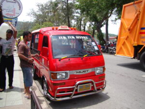 Tuk tuk taxi on Phuket Beach road.