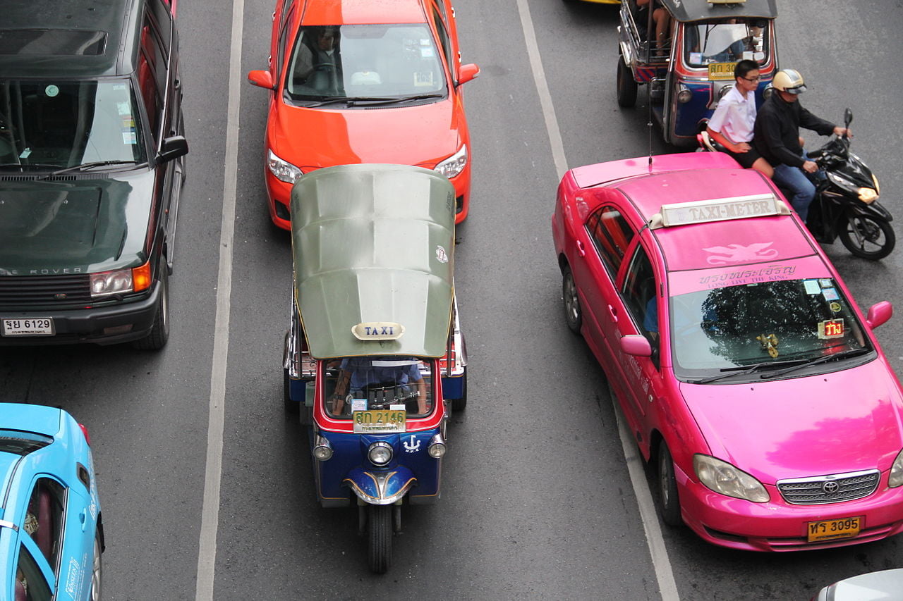 A tuk tuk and a taxi in Bangkok