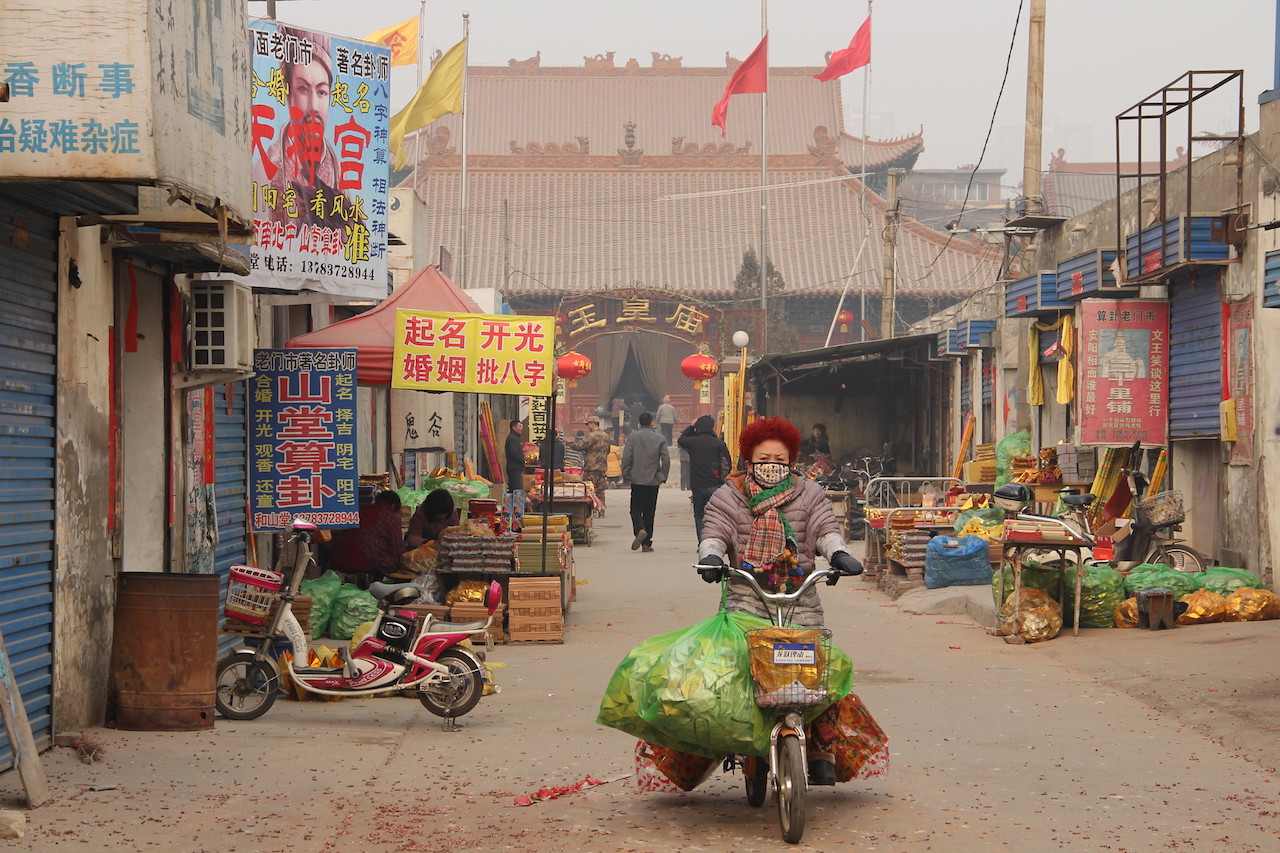 Woman riding a bicycle in Anyang City, China