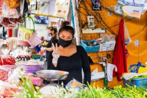 Women wearing mask selling on the market during the COVID-19 coronavirus outbreak in Thailand