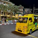 Yellow tuk tuk taxi and minivan in Phuket.