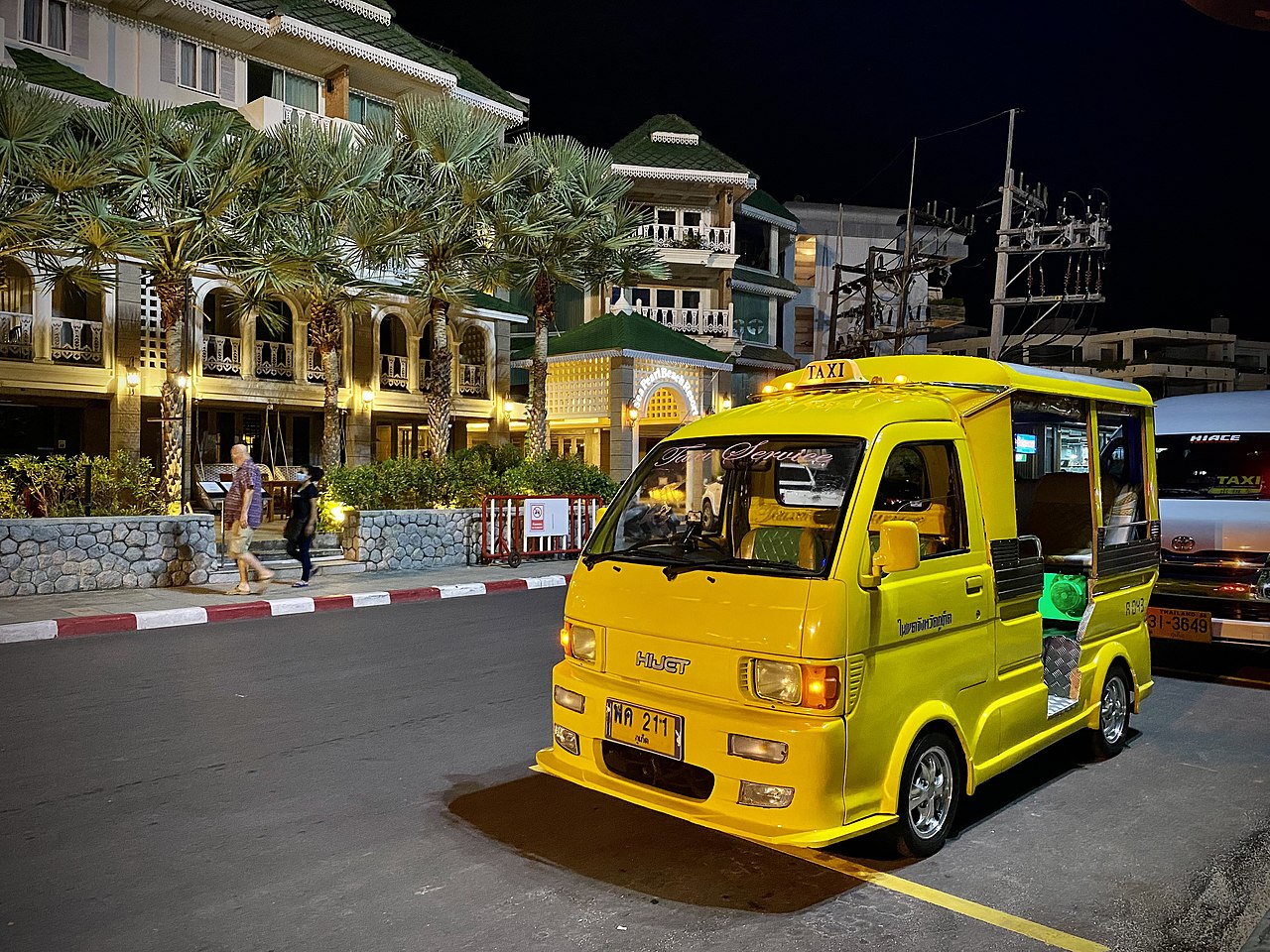 Yellow tuk tuk taxi and minivan in Phuket.