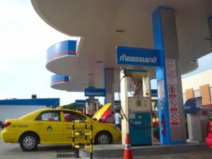 Yellow cab refueling at a PTT service station in Thailand.