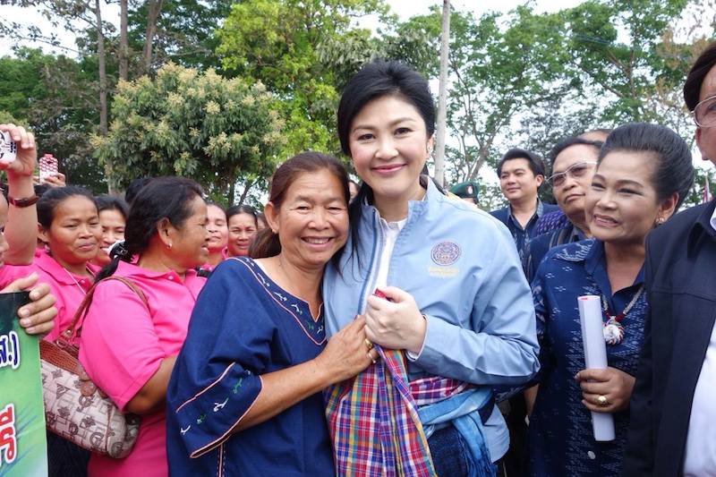 Yingluck Shinawatra surrounded by supporters