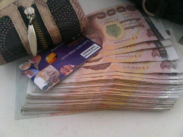 Thai Baht banknotes and a credit card.