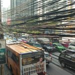 Bus and power cables on a busy street in Bangkok