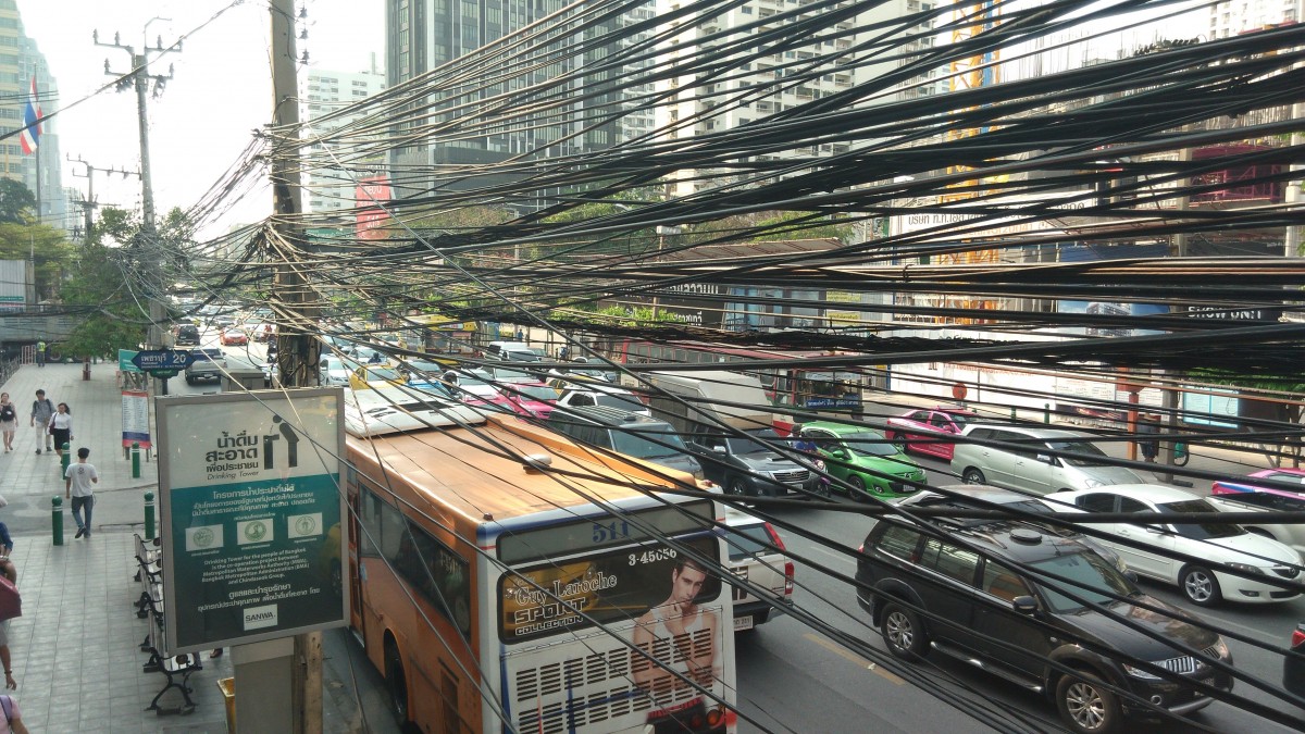 Bus and power cables on a busy street in Bangkok