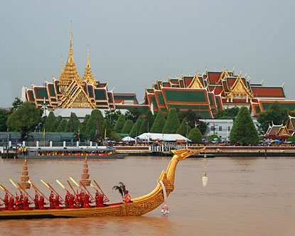 Temple and barge at Chao Phraya river in Bangkok.
