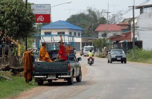 Monks boarding a pickup truck in Kalasin, Thailand
