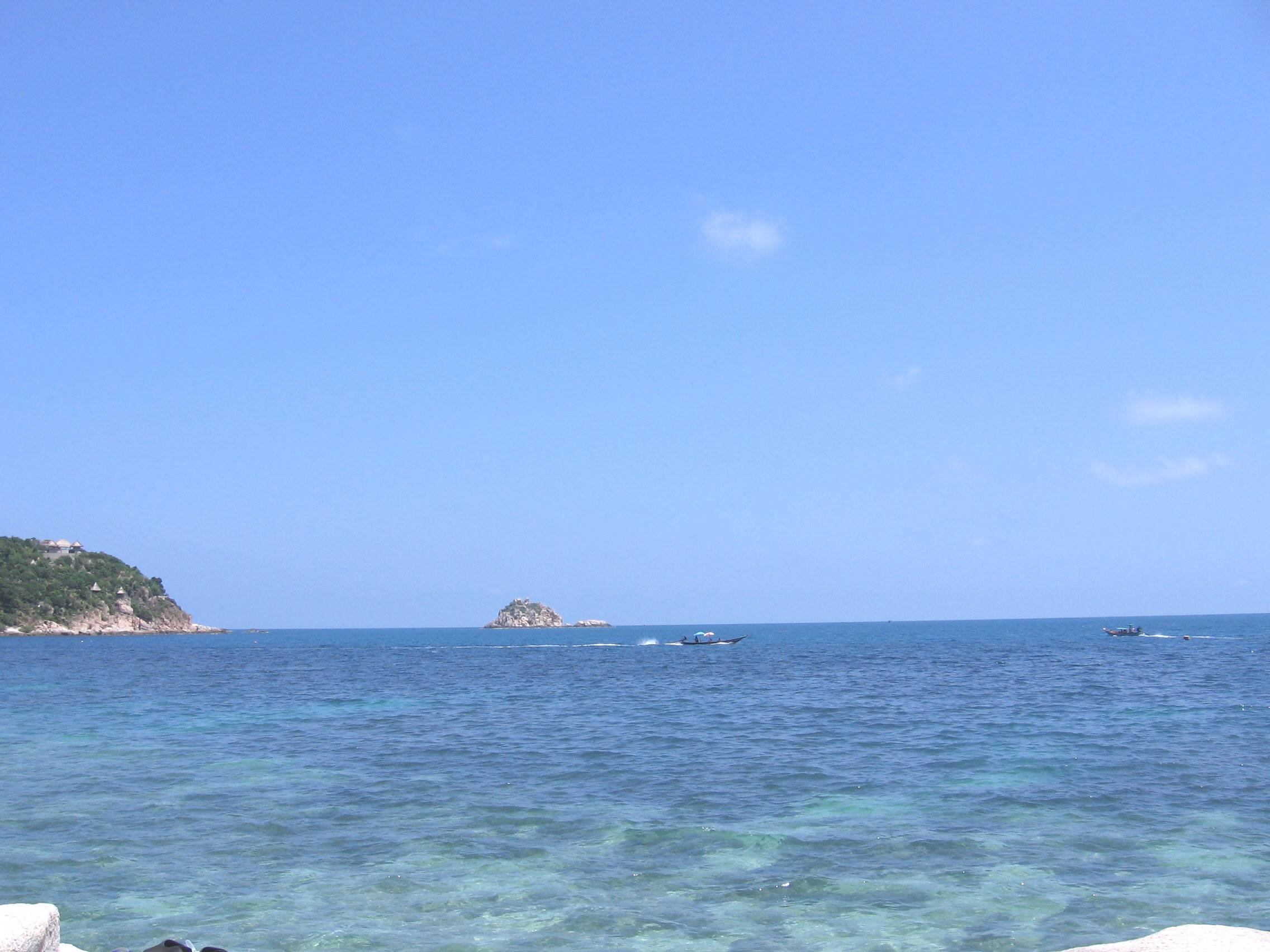 Boats sailing near a small island in Koh Tao.