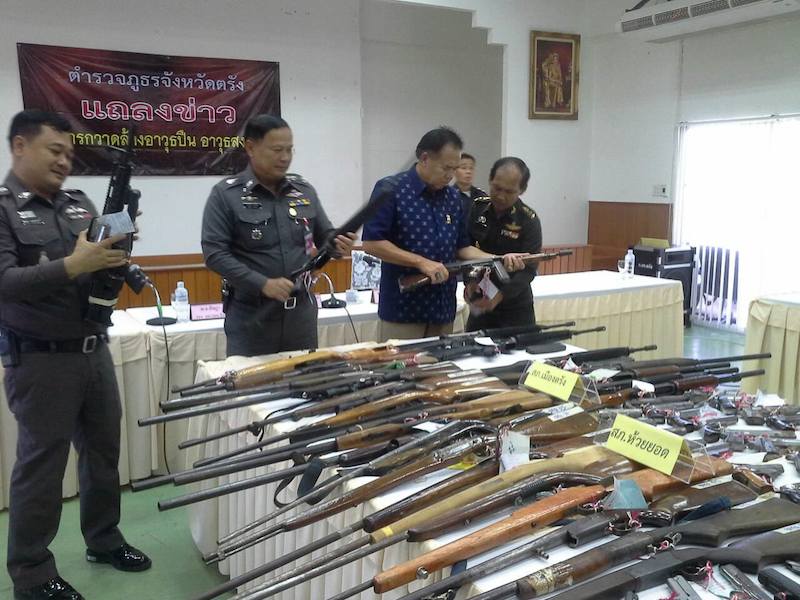 Thai police in a press conference with seized guns