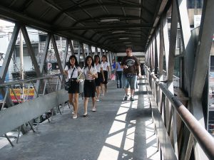 Thai schoolgirls at pedestrian overpass in Bangkok
