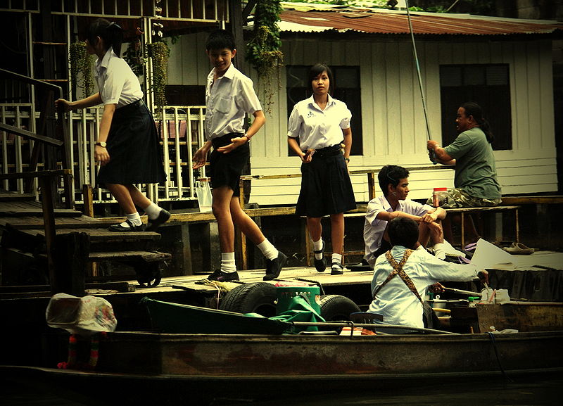 Thai schoolgirls coming back from school by boat