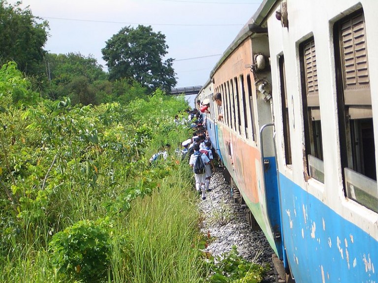 Thai Schoolchildren boarding a train