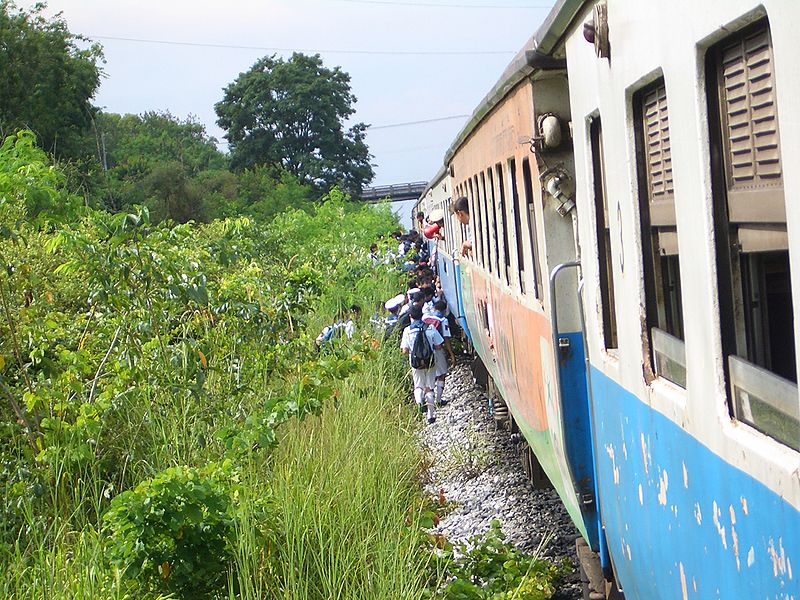 Thai Schoolchildren boarding a train