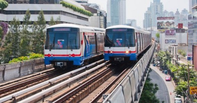 Two BTS SkyTrains pass each other at the Nana station on the Sukhumvit Line