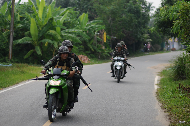 Thai troops patrolling a village in Pattani, to protect Buddhist teachers
