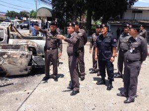 Thai police inspecting burnt out cars