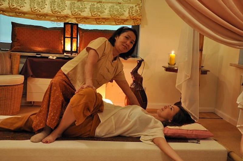 Woman getting a traditional Thai massage
