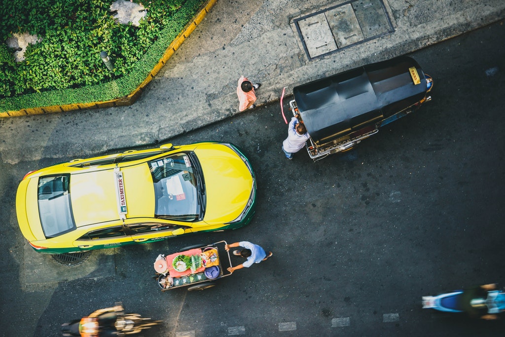 Aerial view of a taxi, tuk tuk and other vehicles in Bangkok
