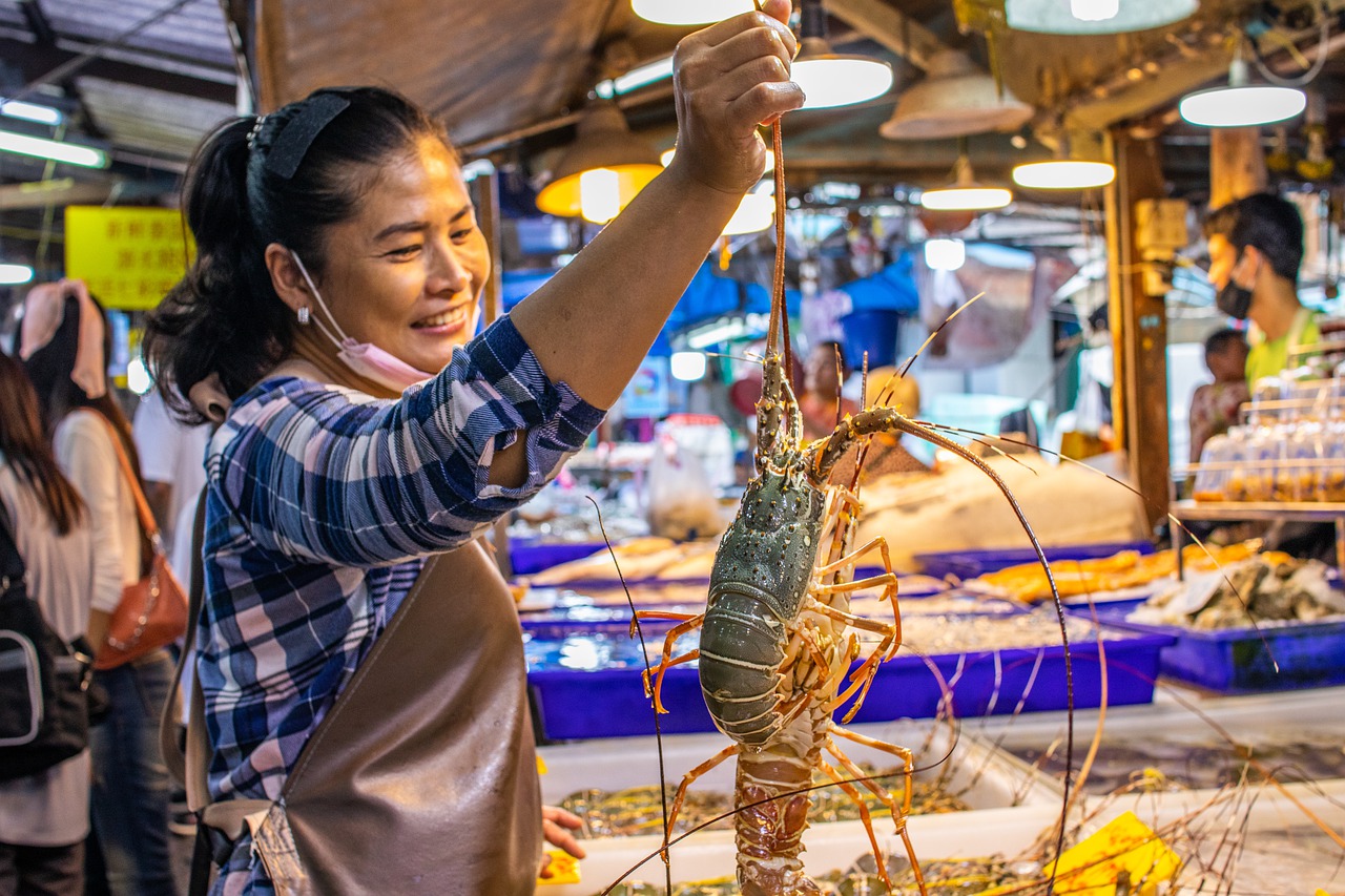 Woman selling seafood at local market in Thailand during the COVID-19 pandemic